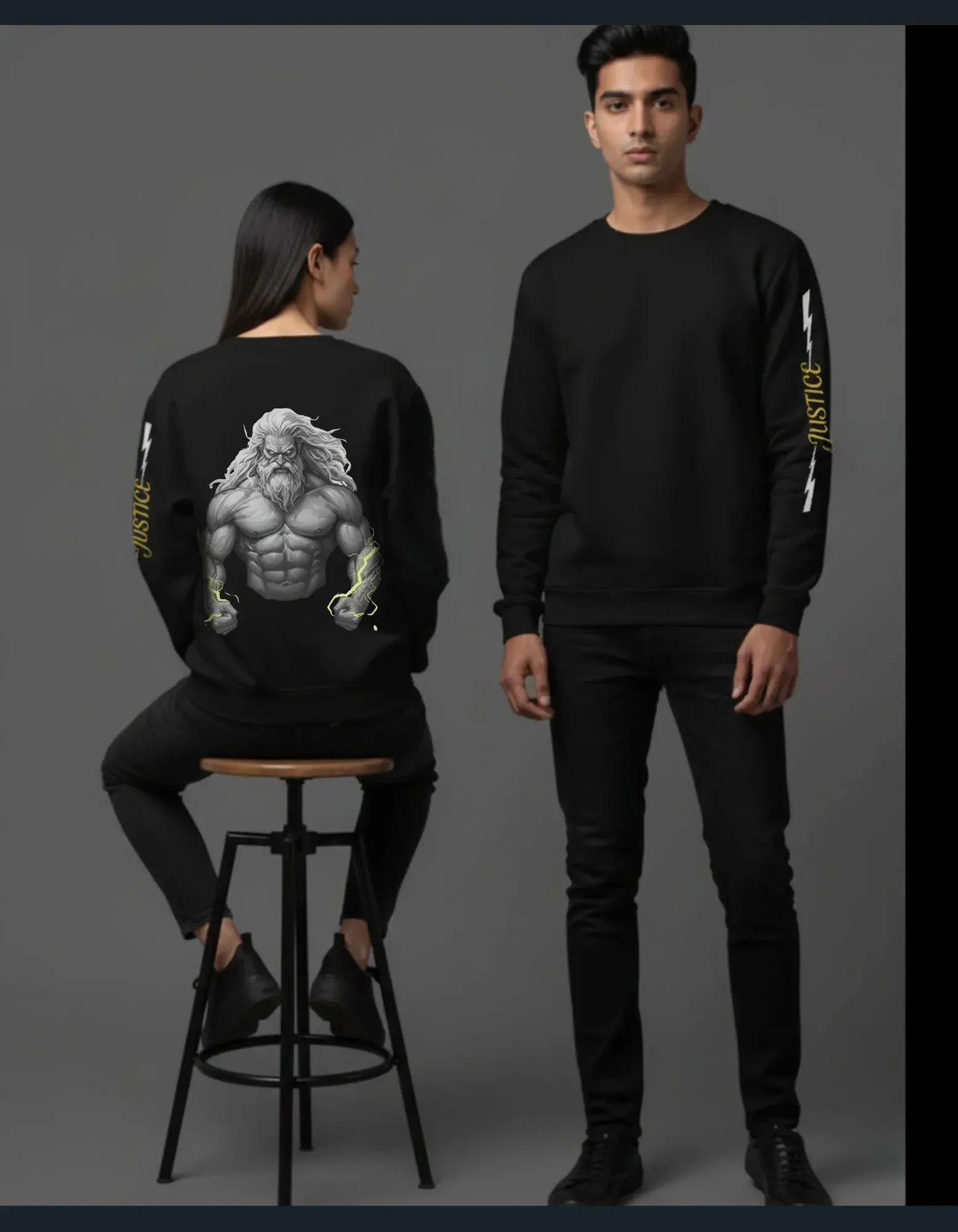 Two people wearing black sweatshirts with graphic designs on a gray background